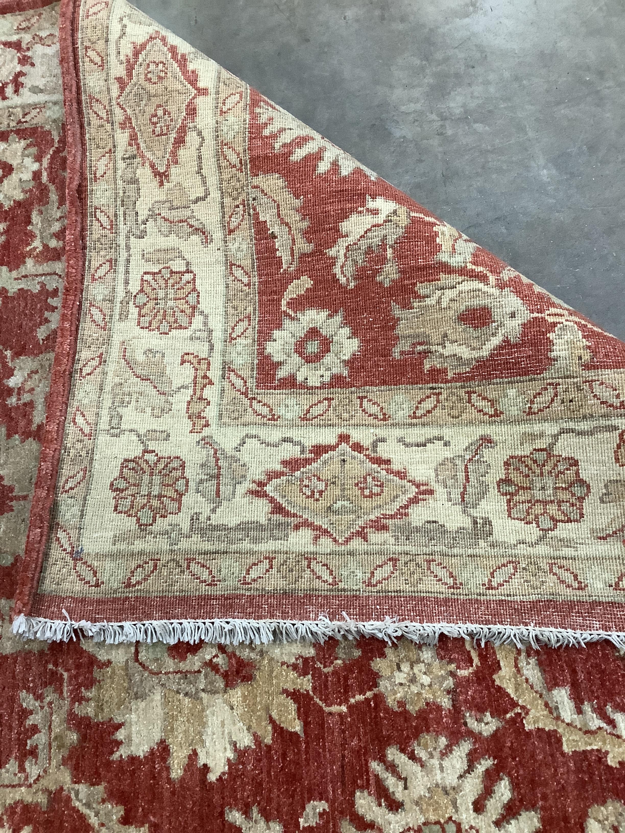 A Ziegler style burgundy ground rug, 220 x 150cm